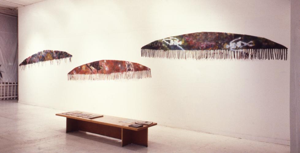 long fringed wall works installed in a gallery