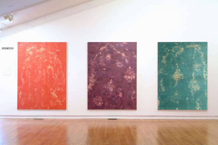 three large paintings from left to right pinkish, purplish, and greenish