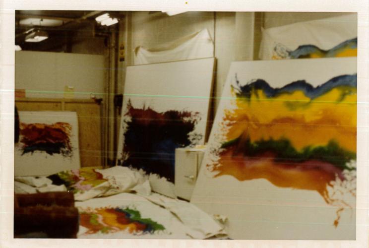 paintings piled in the studio