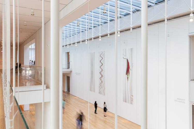 image of a large open atrium with art on the walls and many skylights