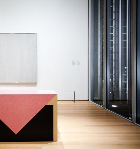 A Richard Artshwager table work on the left with a white monochrome painting behind inside the MoMA