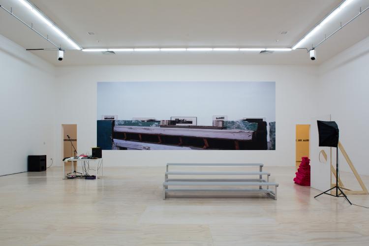 image of a bleacher stand in front of a photograph and some audio equipment at PS1, Queens