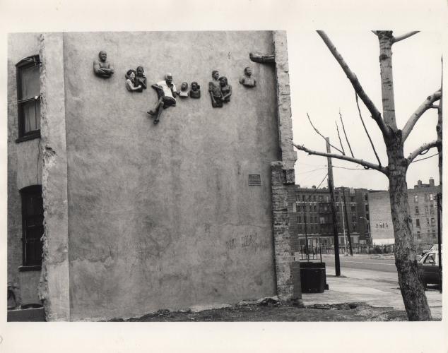 an older photograph of 3D busts relief from the side of a building