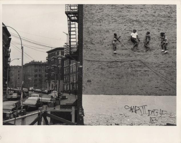 a black and white photograph of sculptural figures relief on the side of a building