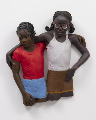 sculptures of two girls with arms around their shoulders