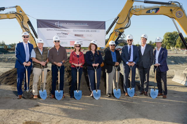 Group photo of stakeholders wearing white hard hats and holding shovels, taken at the groundbreaking for the Verizon Media headquarters in San Jose, CA.