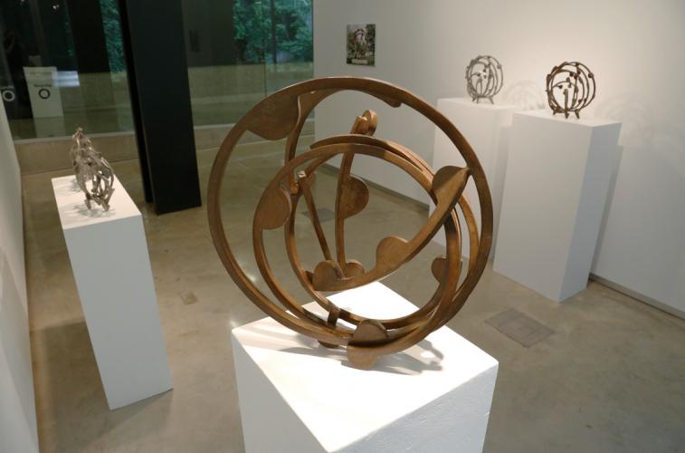 Photo of a brown, circular metal sculpture 
