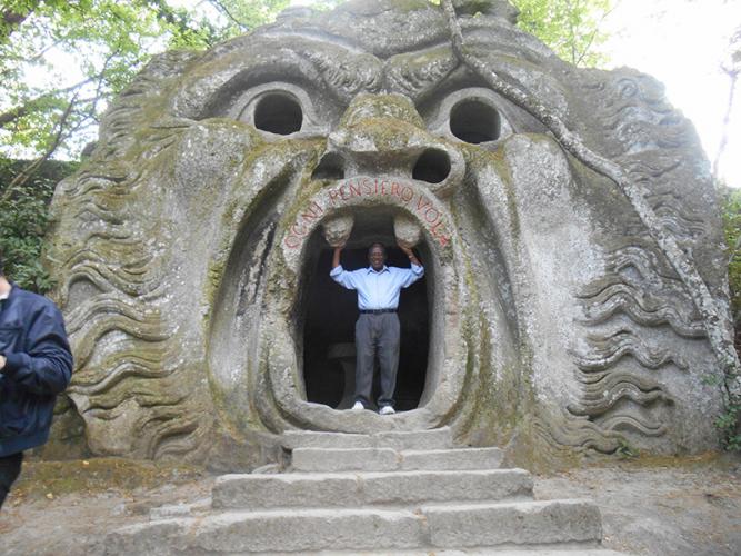 Henry Richardson standing inside mouth of a large animal sculpture