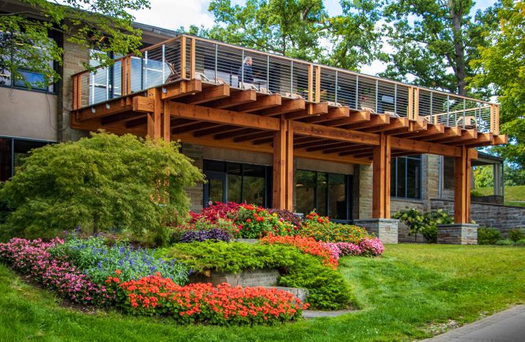 Wooden terrace overlooking flowers and greenery