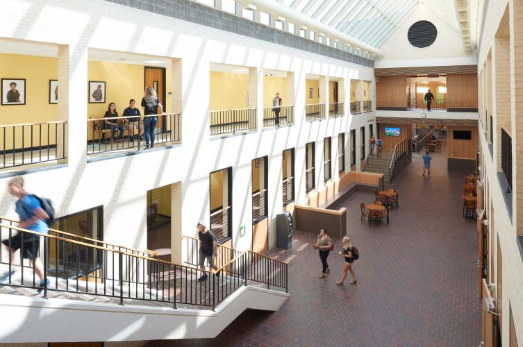 Building interior, view of first floor hallway and stairs, and second floor