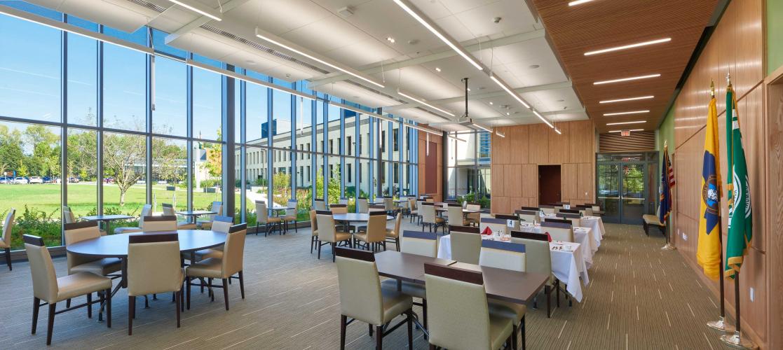 Meeting tables in room with a wall of windows