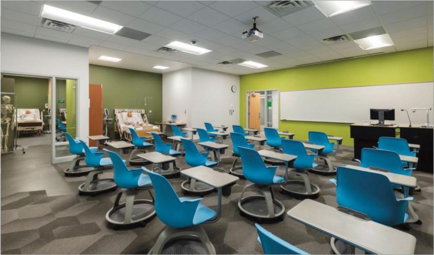 Inside a classroom with bright blue chairs and lime green walls with white trim