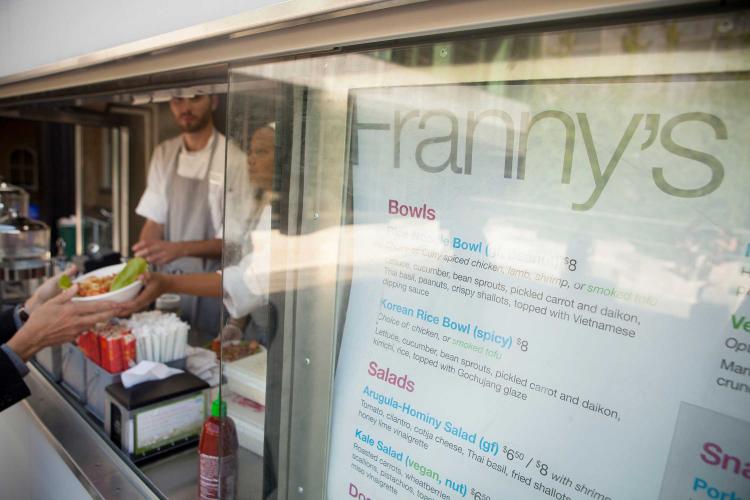 A menu hangs in the window of Franny's Food Truck