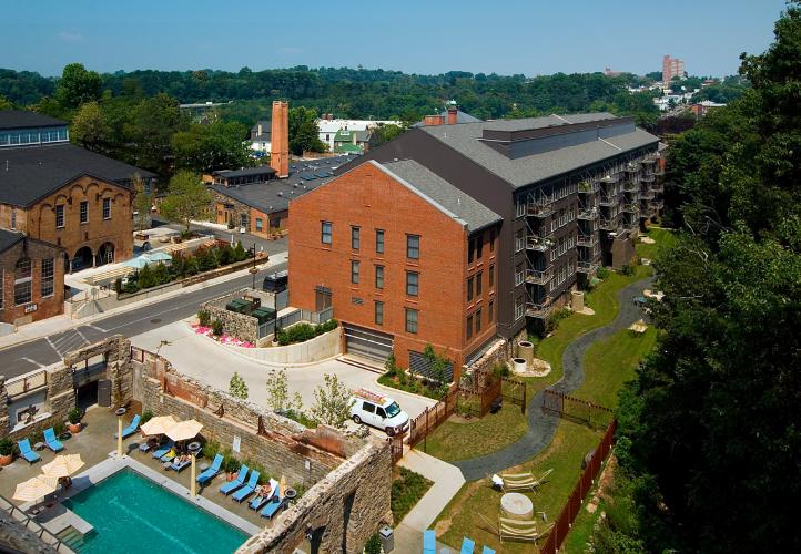 Exterior view of a red brick building next to a private swimming pool