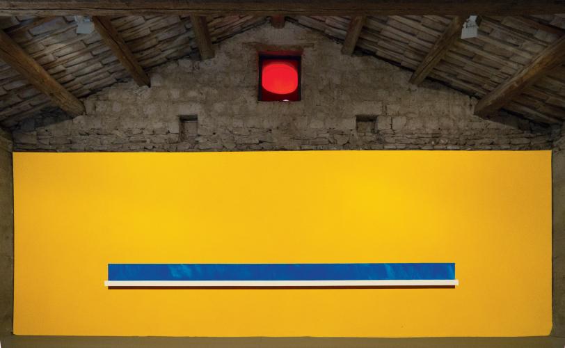 Yellow wall paint on plaster with blue, white, and red rectangles