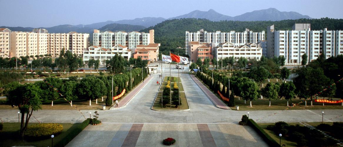 Aerial view of many eight-story dormitory buildings and smaller apartment buildings. 