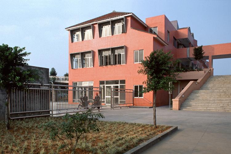 Exterior view of a brick red building.