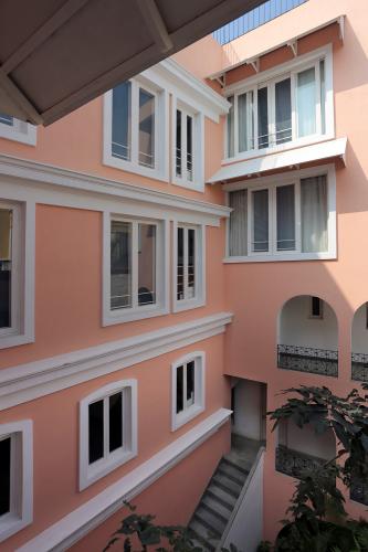 Coral0-colored building facade viewed from the courtyard.