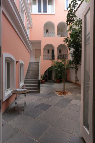 A courtyard with a tiled floor and stairs leading up into the building.