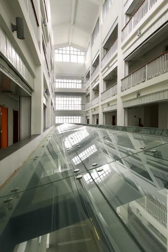 View from ground floor of railings lining upper floors overlooking the atrium.