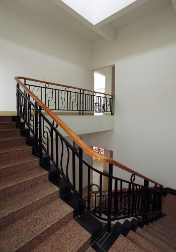 A decorative railing adorns an interior stairway.