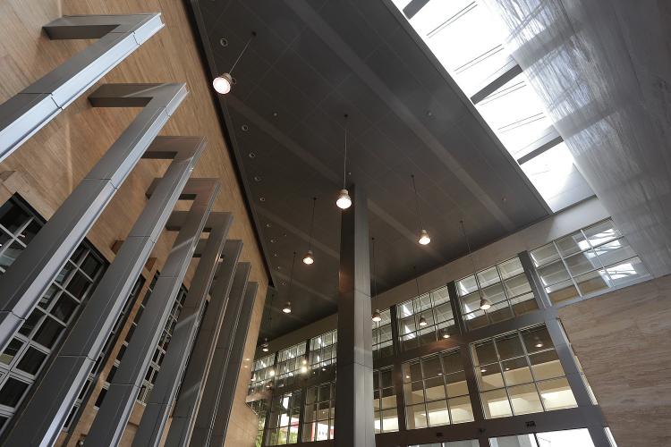 View of a lobby with wooden walls and metal beams.