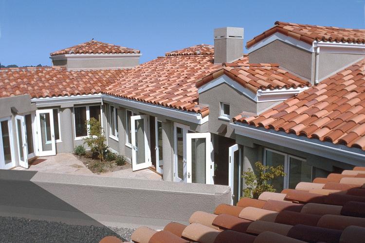 Light and dark red shingles cover the roof of a private residence.