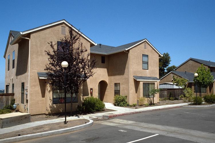 Exterior view of a tan-colored duplex unit.