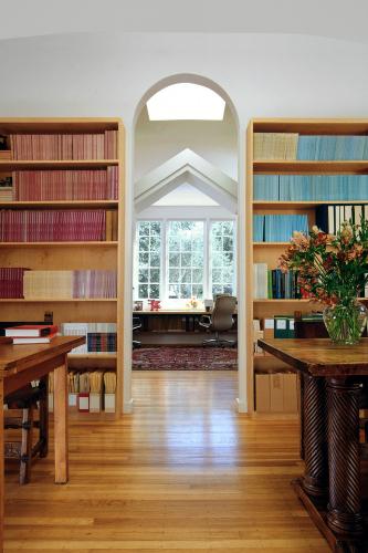 Bookshelves filled with books line a wall. 