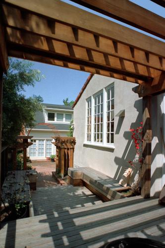 A wooden seating area outside the house.