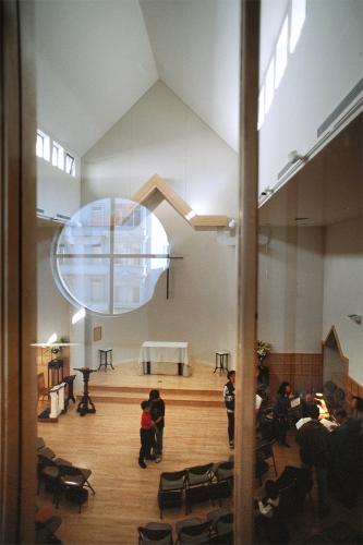 Two people dance in the center of the chapel.