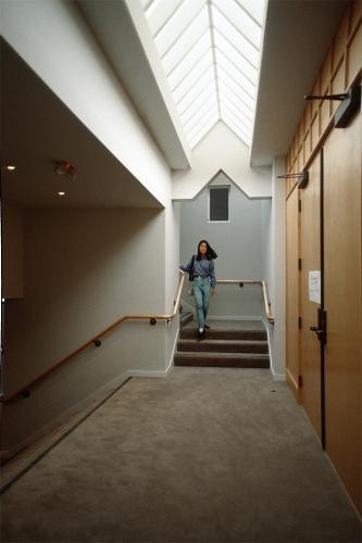 A woman exits a stairwell. 