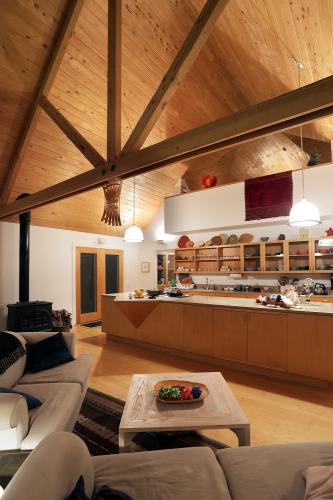 An open kitchen featuring long counters and a wall lined with cupboards. 