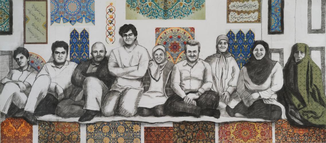Charcoal portrait of a multigenerational family. The men wear casual, Western-style clothing. Three women wear hijabs. An older woman wears a patterned, green chador. Colorful patterned tapestries cover the wall behind the family and the front of the stage they sit on. 