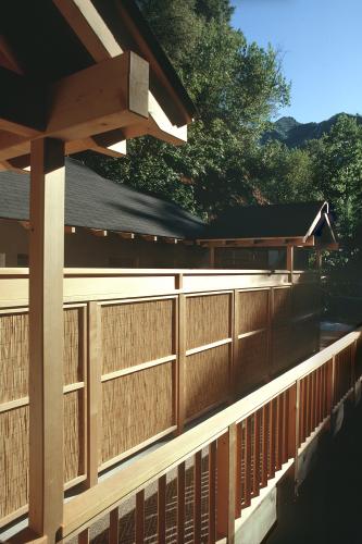 An outdoor wooden walkway leads to the bath house. 