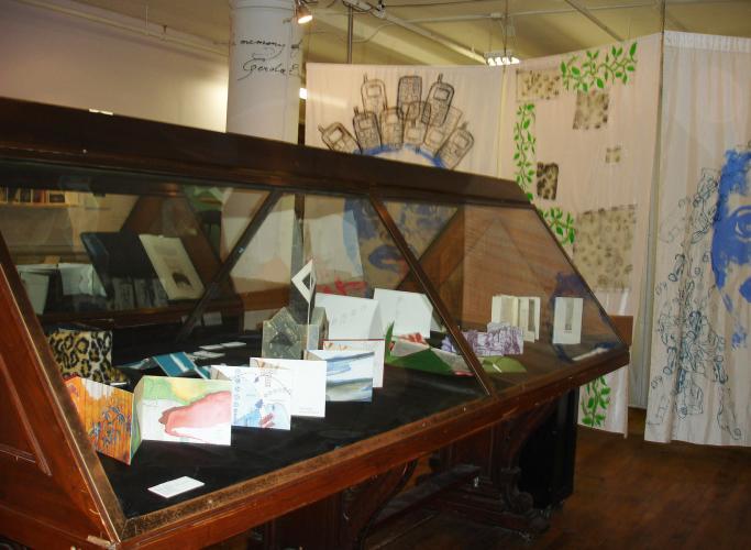 A triangular display case houses illustrated 3-D art.