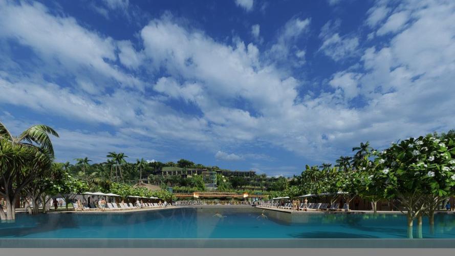 A vivid blue sky and fluffy white clouds serve as the backdrop for a large resort pool.