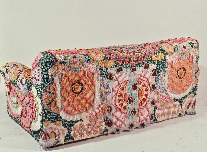 Back of colorful couch with doily motifs.