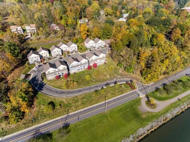 Aerial view of a cul-de-sac of duplex houses.