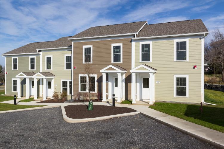 Front exteriors of four attached homes.