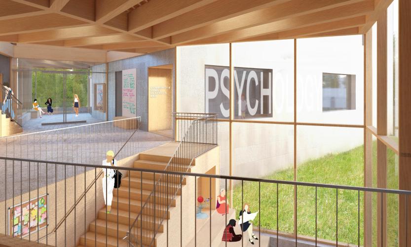 Interior view of a stairwell and glass wall looking out at another window adhered with large letters spelling the word "Psych."