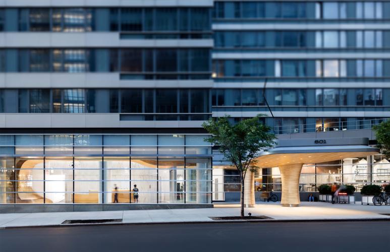 Lobby-level view of a multi-floor apartment building.