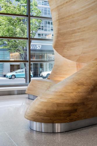 Close-up view of wooden architectural detail in apartment building lobby.