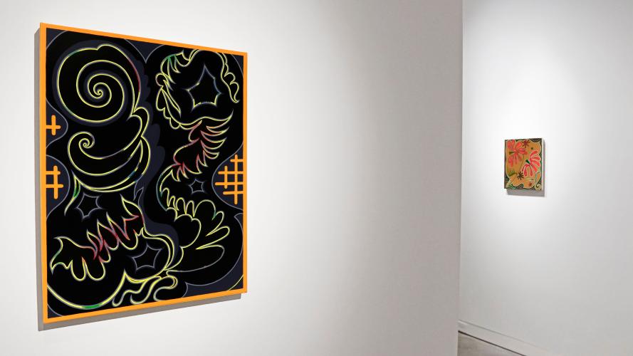 An abstract painting, featuring yellow swirling lines on a black background with an orange border, hangs on a wall in a gallery.