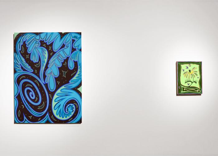 An abstract painting with various shades of blue and a smaller painting of a flower, using various shades of green, hang on a wall in a gallery.