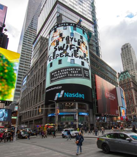 A circular billboard in NYC shows an ad for the Taylor Swift Experience.