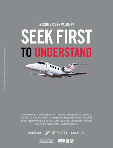 Advertisement for JetSuite airline: JetSuite Core Value #4 'Seek First to Understand' in large letters and an image of a plane on a gray background