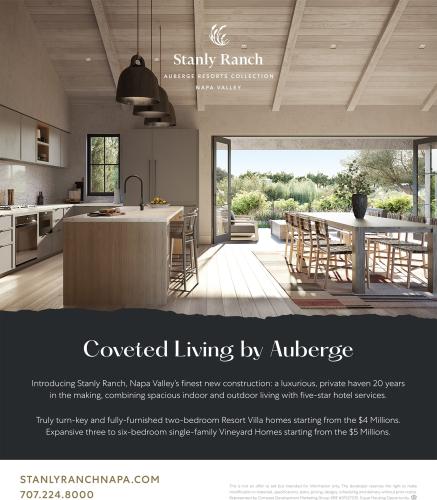 An advertisement for Stanly Ranch luxury resort villa homes. The ad shows an open-concept living space with a kitchen, dining area, and a wide, open doorway to a patio and garden.