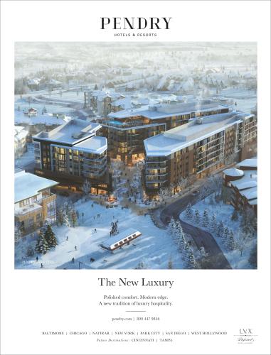 An advertisement for a luxury hotel, showing an exterior aerial view of the hotel on a wintry day.
