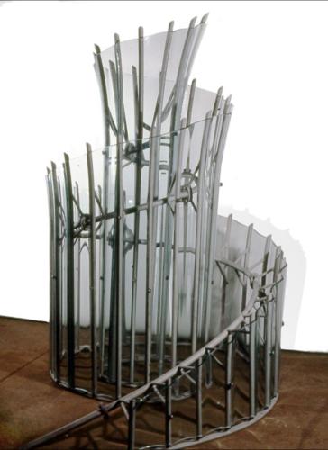 A spiral-shaped sculpture made of steel and slumped glass.